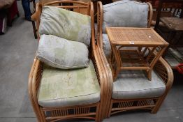 A pair of modern bent wood conservatory arm chairs with side table