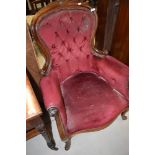 A Victorian button back armchair having dralon uphostery on scroll frame