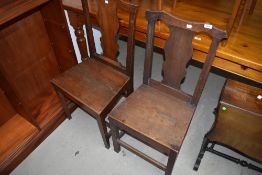 Two traditional Victorian hall way chairs having plank top oak seats with shield back