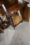 An early 20th Century oak occasional table and a strung stool