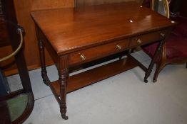 A Victorian mahogany side table having two drawers and turned legs