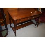 A Victorian mahogany side table having two drawers and turned legs