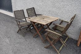 A set of four teak garden chairs with matching table set