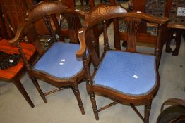 A pair of Edwardian mahogany corner salon chairs