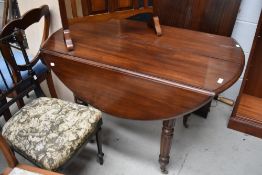 A vintage mahogany extending kitchen dining table