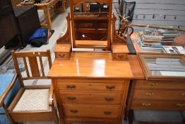 A late Victorian dressing table with chest of three drawers having bevel edged mirror