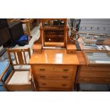 A late Victorian dressing table with chest of three drawers having bevel edged mirror