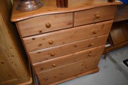 A modern pine bedroom chest of two over four drawers, having serpentine front, width approx. 95cm
