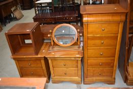 A modern set of satin wood furniture including two bedside cabinets, a tall boy a cheval mirror