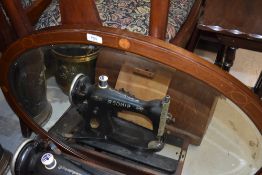 An Edwardian mahogany and inlaid oval wall mirror