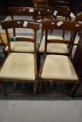 A set of four Victorian mahogany rail back dining chairs, signs of some past worm