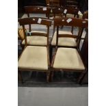 A set of four Victorian mahogany rail back dining chairs, signs of some past worm