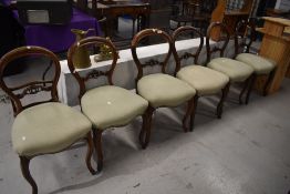 A set of six Victorian mahogany dining chairs having scroll rail back and overstuffed seat