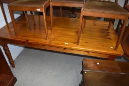 A modern light pine farm house style solid kitchen table