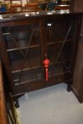 An early 20th Century mahogany display cabinet having astral glazed doors and two lower drawers