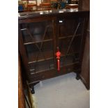 An early 20th Century mahogany display cabinet having astral glazed doors and two lower drawers