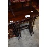 An early 20th century mahogany next of tables, on fine legs