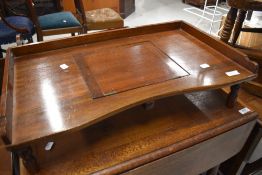 A vintage stained frame bed tray