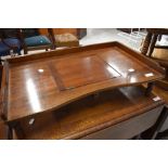 A vintage stained frame bed tray