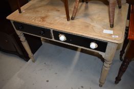 A Victorian part stripped side table having drawers and turned legs