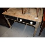 A Victorian part stripped side table having drawers and turned legs