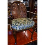 An early 20th Century stained frame armchair having bergere back