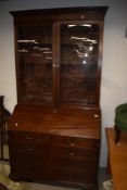 A 19th Century mahogany bureau bookcase, the upper section having wooden shelves behind astral