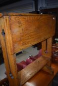 An Arts and Crafts golden oak drop leaf standing table having twist top, in the Arthur Simpson