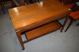 A vintage teak fold over coffee table