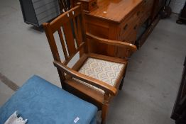 A 20th century golden oak arm chair / comode