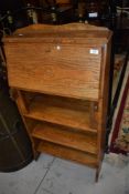 A golden oak Arts and Crafts/shaker style bureau with bookcase under