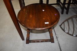 A small circular oak framed coffee table