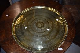 A vintage brass tray, having hieroglyphic and other decoration, width approx. 58cm