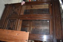 A Victorian library book case having rolled glass frontage with drawer storage