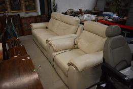 A modern cream leather electric recliner suite comprising two seater settee and chair, cost £1500