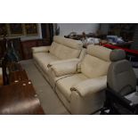 A modern cream leather electric recliner suite comprising two seater settee and chair, cost £1500