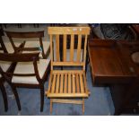 A vintage light stained frame steamer style folding chair