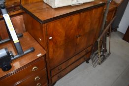 A 20th century mahogany flame fronted chest of two drawers and cupboard