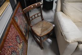 A 19th Century kitchen rocking chair having seagrass seat