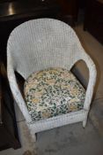 A Lloyd Loom or similar tub chair