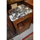 An early 20th Century bedside cabinet having marble top