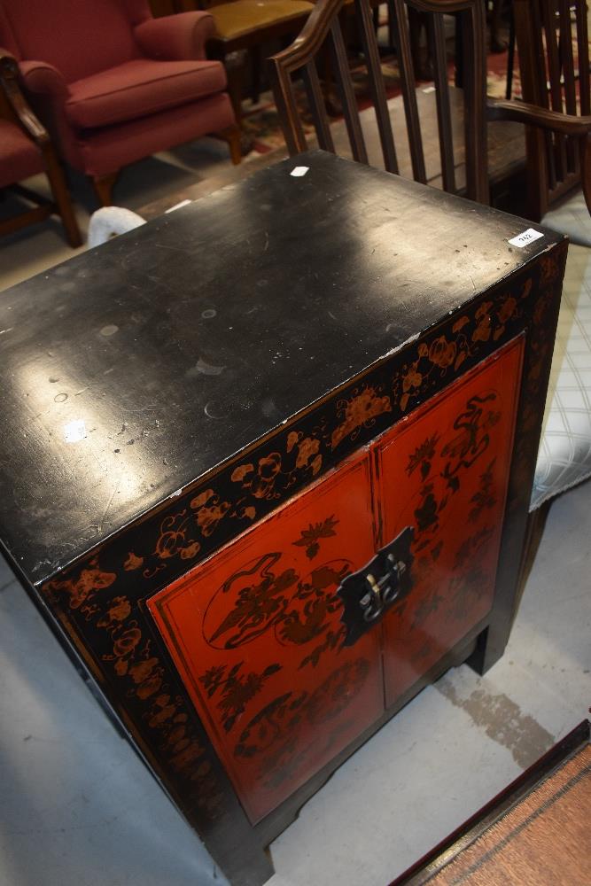 A laquered oriental style side cabinet