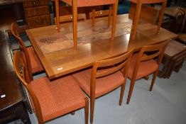 A vintage teak and tiletop extending dining table and either complimentary dining chair