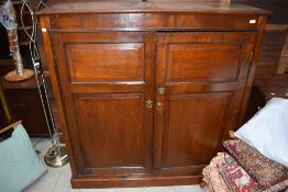 An antique oak cased utility or storage cupboard having four shelf