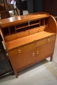 A vintage teak or sapele roll top desk, width approx. 85cm