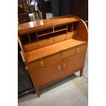 A vintage teak or sapele roll top desk, width approx. 85cm