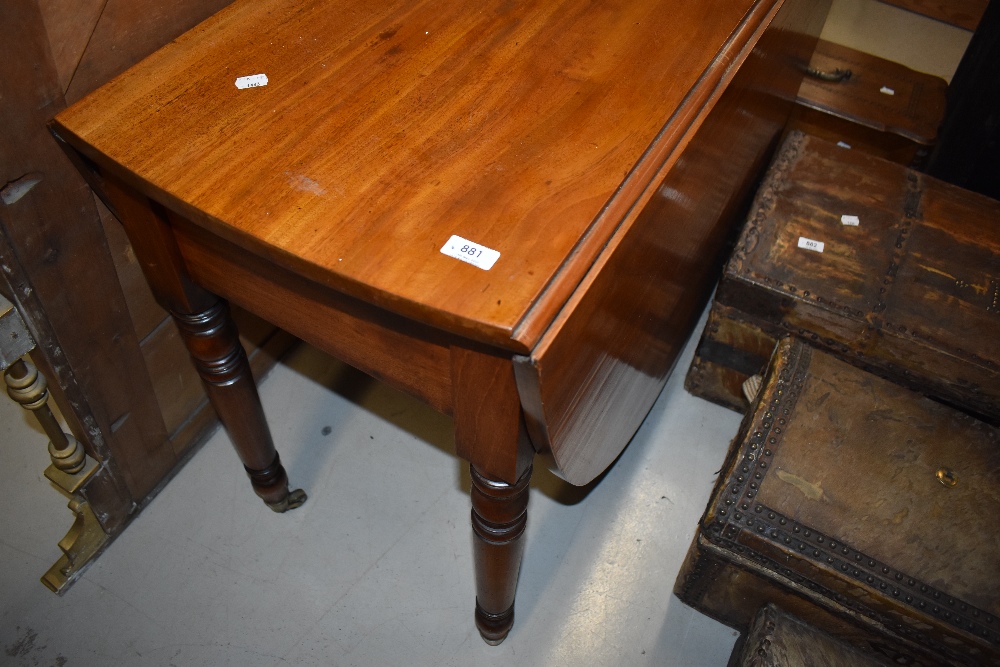A Victorian mahogany drop leaf dining table having turned legs