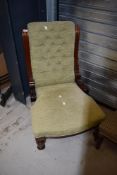 A 19th Century button back nursing chair having mahogany frame and later upholstery