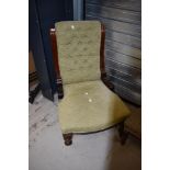 A 19th Century button back nursing chair having mahogany frame and later upholstery