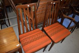 A pair of vintage teak rail back dining chairs